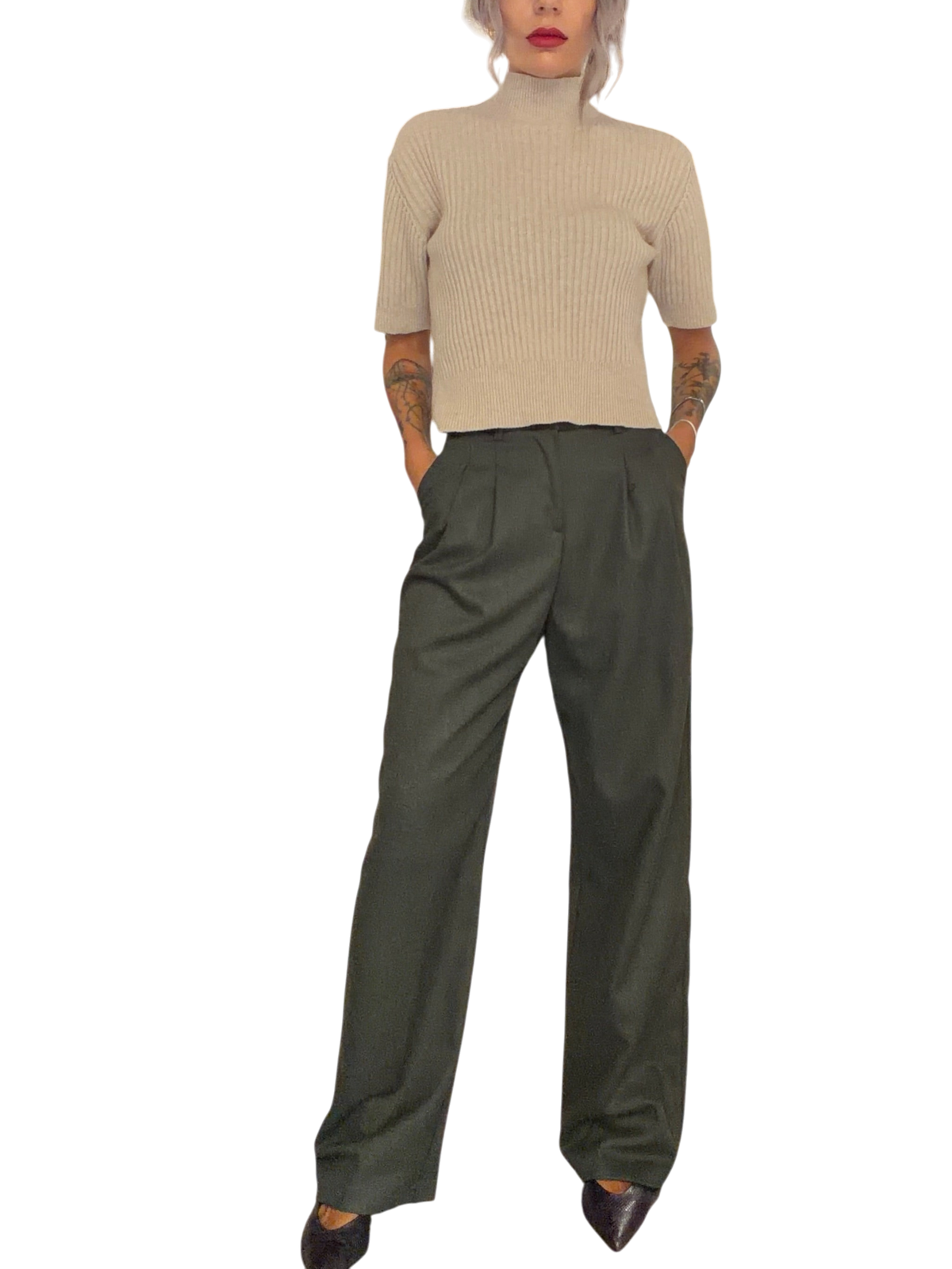 Modella indossa pantalone palazzo Blaze Shop verde loden a vita alta con doppie pinces in un negozio di abbigliamento